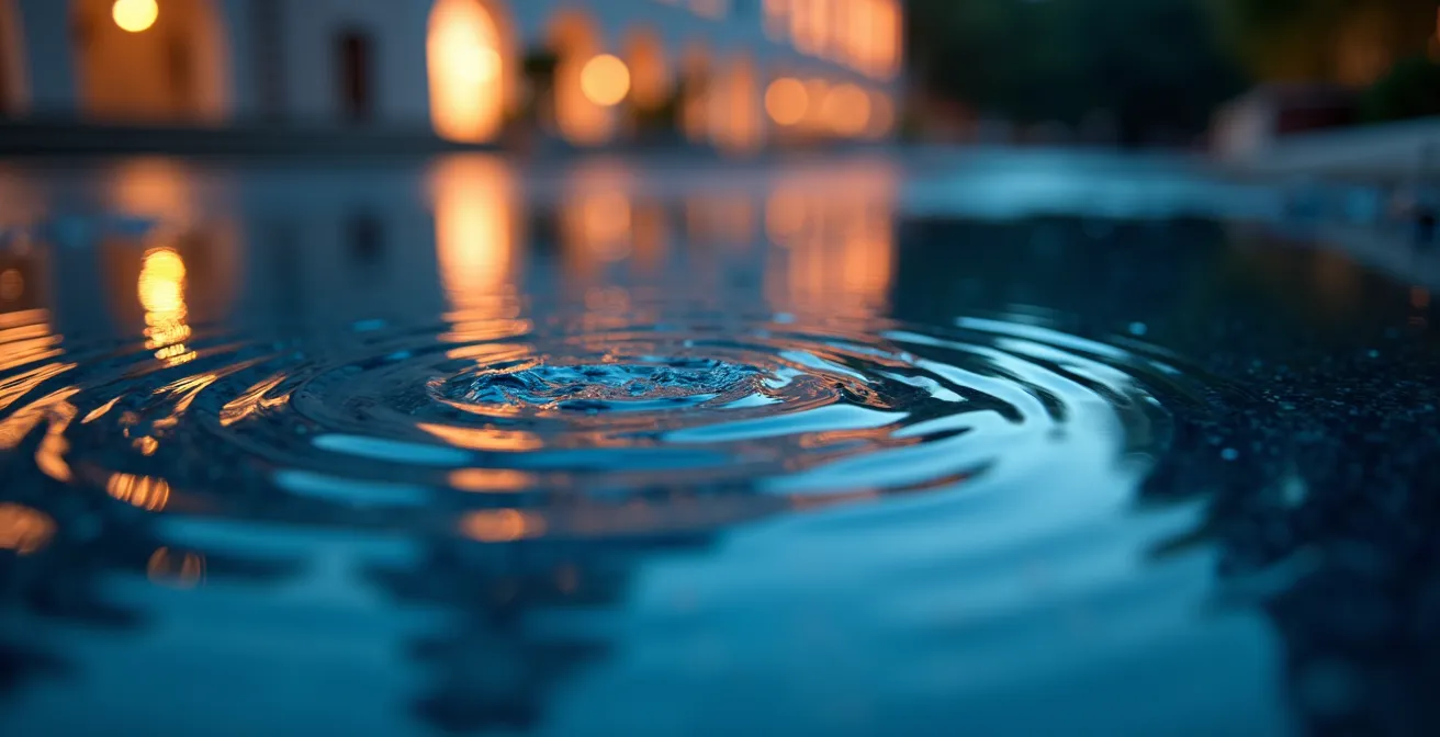 Luxury hotel reflected perfectly in calm water surface during blue hour